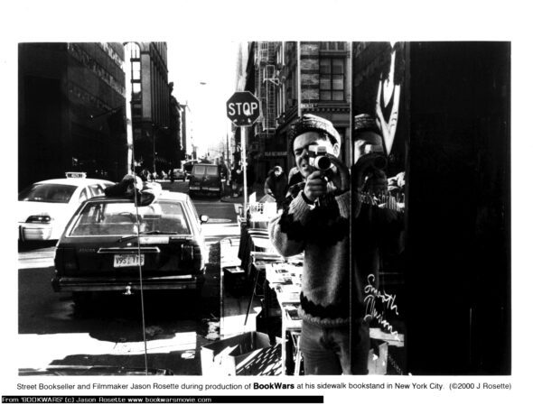 Filmmaker-producer Jason Rosette shooting ''BookWars'' in the mid-1990s at his Manhattan sidewalk book stand - from 'BookWars'